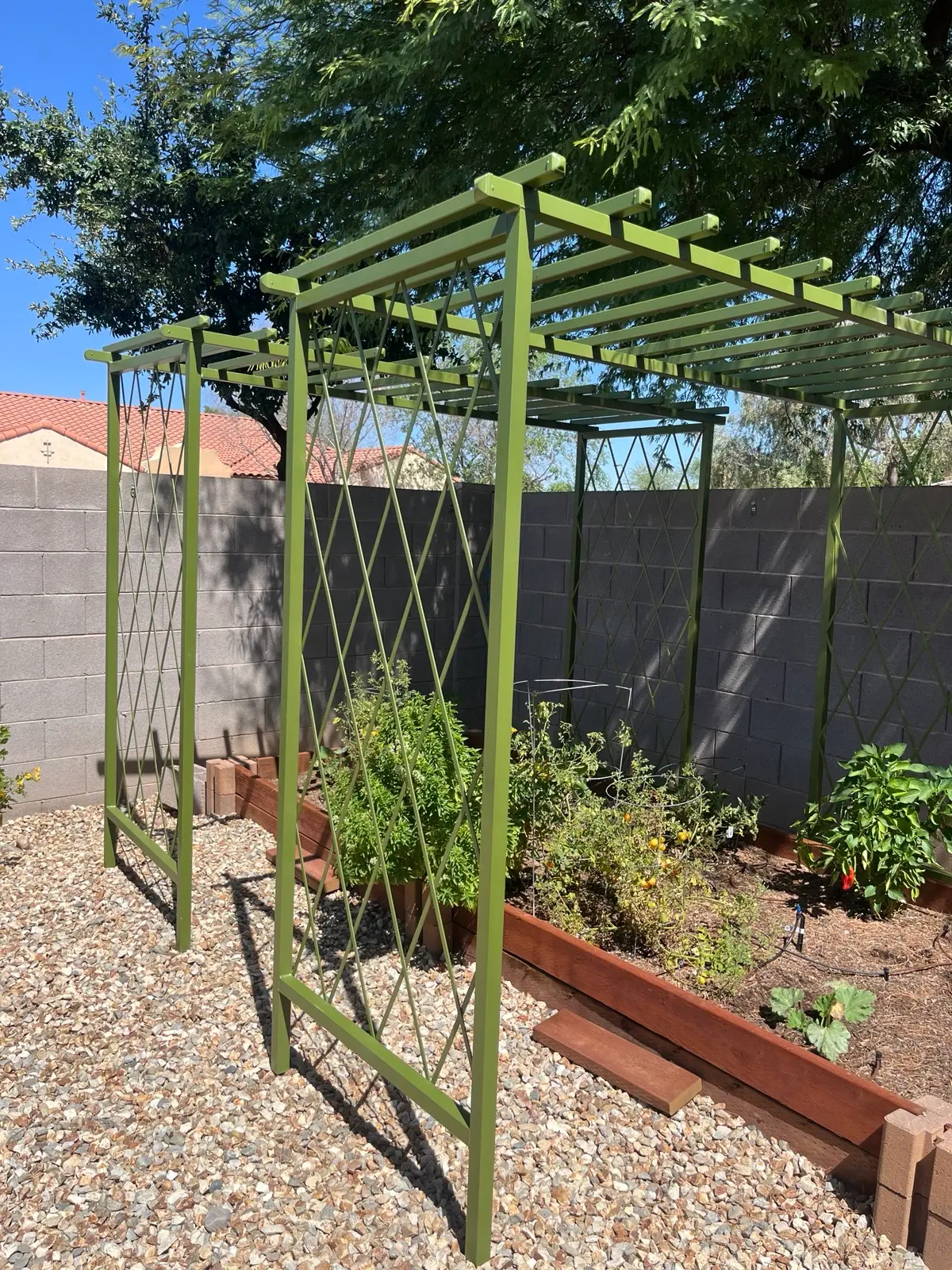 Custom sage-green steel garden pergola over a raised bed, hand-built by A1 Trellis in Chandler, Arizona